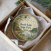 A round ornament with a scenic image of Beeds Lake State Park, Iowa, hanging from a string.