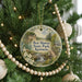 A round ornament on a Christmas tree, featuring a scenic landscape with a waterfall and a bridge, with the text "Ben Hawes State Park, Kentucky" displayed on it.