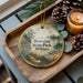 A wooden tray with a decorative ornament featuring a scenic landscape of Bewabic State Park, Michigan, and pine cones.