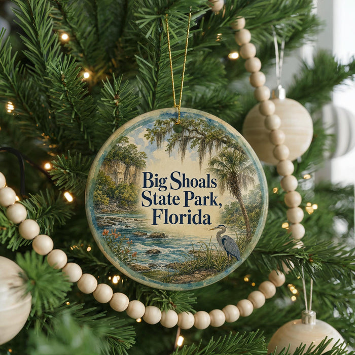 A round ornament hanging on a Christmas tree, featuring a scenic image of Big Shoals State Park in Florida.