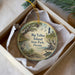 A decorative ornament in a box, featuring a scenic image of Big Talbot Island, Florida, with a lighthouse and birds in the background.