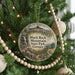 A round ornament hanging on a Christmas tree, featuring a scenic image of Black Rock Mountain State Park, Georgia.
