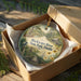 A decorative ornament in a wooden box, featuring a scenic image of Blackwater River State Park, Florida.