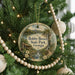 A round ornament hanging on a Christmas tree, featuring a scenic image of Bobby Brown State Park in Georgia.