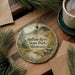 A round ornament with a scenic image of Buffalo River State Park, Minnesota, hangs on a wooden surface.
