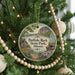 A round ornament hanging on a Christmas tree, featuring an illustration of buffalo rock state park in Illinois.