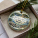 A decorative ornament in a box, featuring a scenic image of the Bull Shoals-White River State Park in Arkansas.