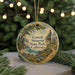 A round ornament with a painting of Caswell Memorial State Park, California, hanging from a string.