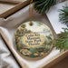 A decorative ornament with a picture of a house and palm trees, along with the text "Cedar Key Museum State Park, Florida" on it, is displayed in a box with pine branches.