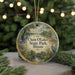 A round ornament with a scenic landscape of Chain O Lakes State Park, Illinois, featuring a bird and flowers, is displayed on a table with a blurred background of a Christmas tree and lights.
