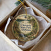 A decorative ornament in a box, featuring a scenic landscape with a waterfall and pine trees, with the text "Chewala State Park, Alabama" prominently displayed.
