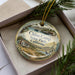 A decorative ornament with a scenic image of China Camp State Park, California, featuring a house, a boat, and a bird.