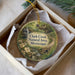 A round ornament with a scenic image of a natural area, specifically Clark Creek, displayed in a box.