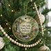 A round ornament hanging on a Christmas tree, featuring a scenic image of Clifftop Falls State Park, Indiana.