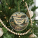 A round ornament hanging on a Christmas tree, featuring a scenic image of Cobscook Bay State Park in Maine.