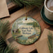 A decorative ornament featuring a scenic lake landscape with a cabin, boat, and pine trees, along with the text "Coldwater Lake State Park, Michigan".