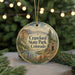 A circular ornament featuring a scenic landscape of Crawford State Park, Colorado, with a mountain backdrop and a river.