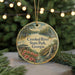 A round ornament with a scenic landscape of Crooked River State Park, Georgia, featuring a waterfall, pine trees, and a bird.