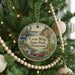 A circular ornament hanging on a Christmas tree, featuring a scenic image of Crow Wing State Park, Minnesota.