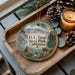 A decorative ornament featuring a scenic landscape of D.L. Bliss State Park, California, with pine cones and a lit candle on a wooden tray.