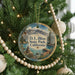 A round ornament on a Christmas tree, featuring a scenic image of D.L. Bliss State Park, California.