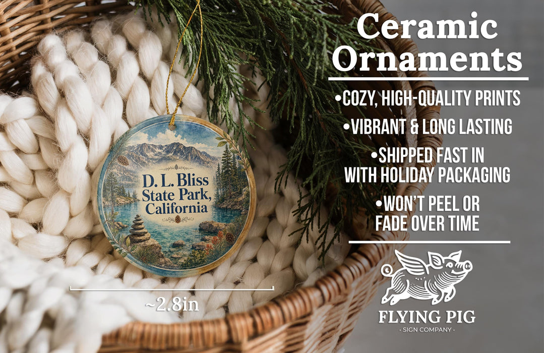 Ceramic ornaments, featuring a round ornament with a scenic landscape of D.L. Bliss State Park, California, hanging from a wicker basket.