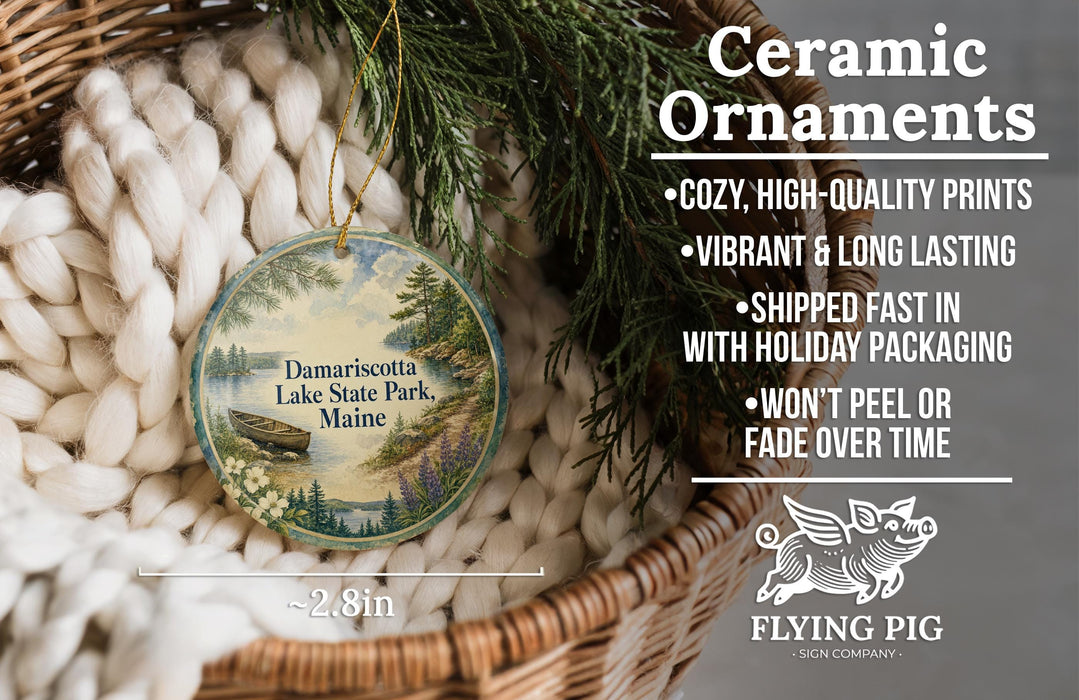 Ceramic ornaments, including a round ornament with a scenic lake view and a wicker basket with greenery.