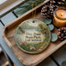 A wooden tray with a decorative ornament featuring a scenic landscape of Day Pond State Park, Connecticut, and pine cones.