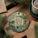 A decorative ornament featuring a scenic image of De Leon Springs State Park in Florida, surrounded by pine branches and a cup of coffee.
