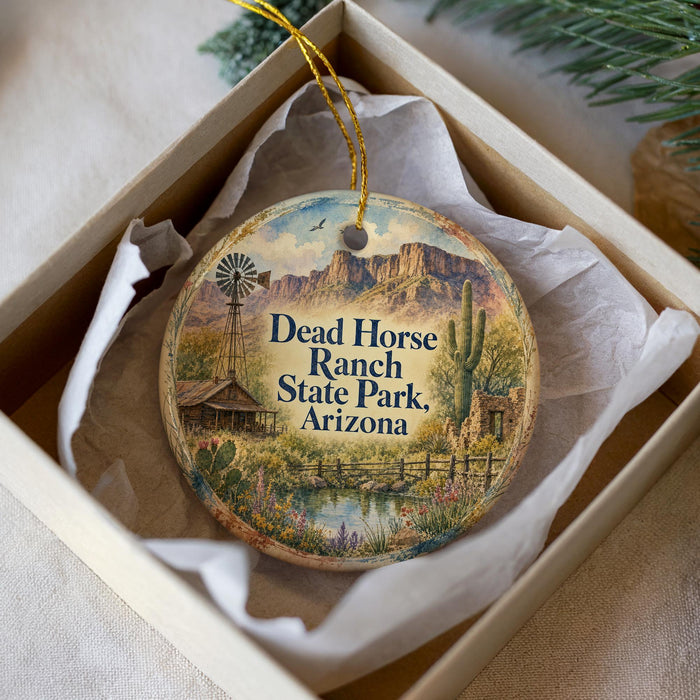 A decorative ornament in a white box, featuring a scenic image of Dead Horse Ranch State Park, Arizona.