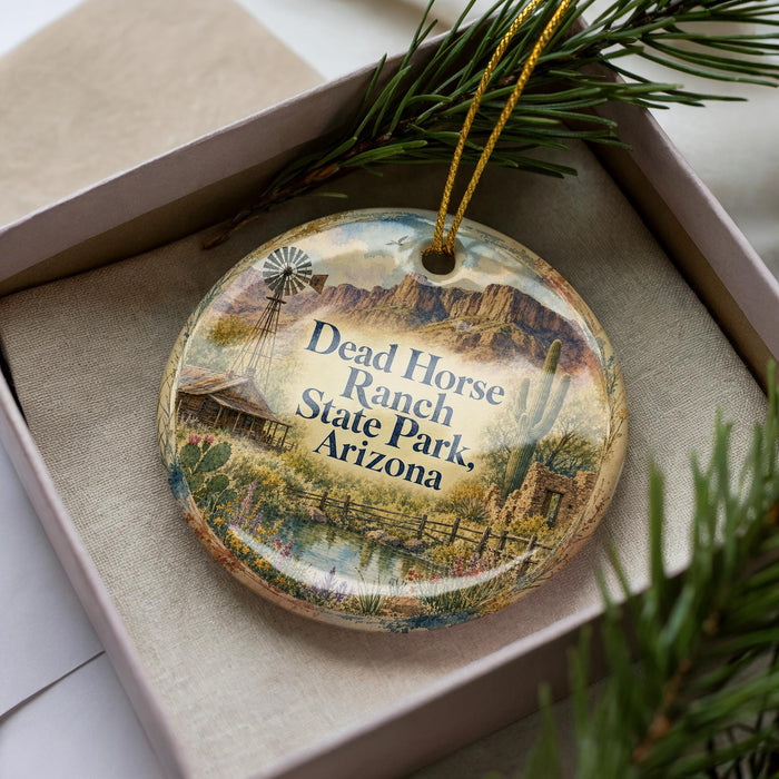 A decorative ornament in a box, featuring a scenic image of Dead Horse Ranch State Park in Arizona.