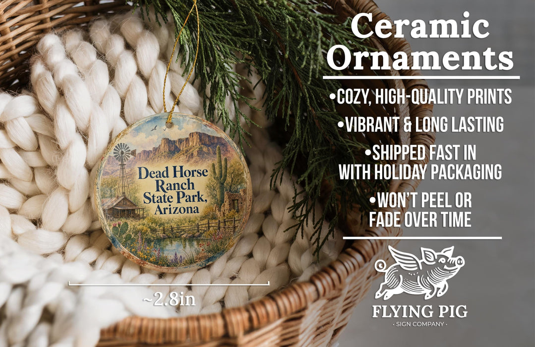 Ceramic ornaments, featuring a Dead Horse Ranch State Park, Arizona ornament, are displayed in a basket with pine branches.