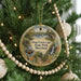 A round ornament hanging on a Christmas tree, featuring a scenic image of Deep Creek Lake State Park, Maryland.
