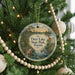 A Christmas tree decorated with ornaments, including a round ornament with a scenic image of Deer Lake State Park, Florida.