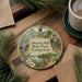A decorative ornament featuring a scenic landscape with pine trees, a lake, and a tower, with the text "Dennis Hill State Park, Connecticut" displayed prominently.