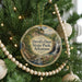 A round ornament hanging on a Christmas tree, featuring a scenic image of Devil's Den State Park in Arkansas.