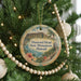 A round ornament on a Christmas tree, featuring a scenic image of Diamond Head State Monument in Hawaii.