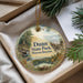 A decorative ornament with a scenic landscape of Dunn State Park, Massachusetts, featuring a cabin, trees, and a lake.