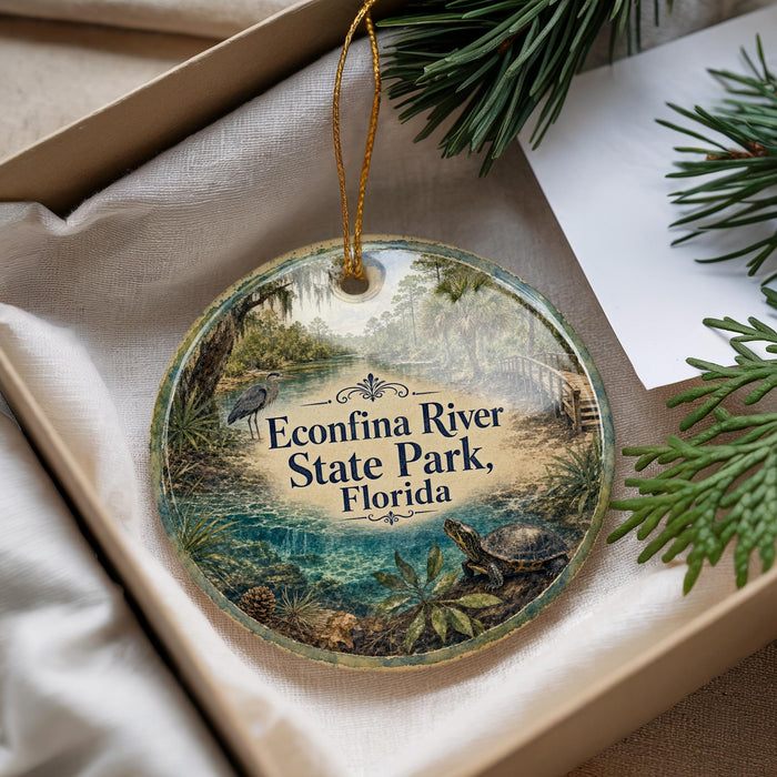 A decorative ornament with a scenic image of the Econfina River State Park in Florida, featuring a bird, a turtle, and lush greenery.
