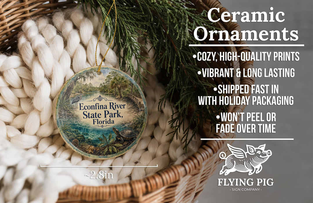 Ceramic ornaments, featuring a detailed image of the Econonna River State Park in Florida, are displayed in a wicker basket. The text highlights the ornaments as "cozy, high-quality prints" and "vibrant and long lasting", with a description of their shipping speed and packaging. The image also includes a logo for "Flying Pig - SIGN COMPANY".