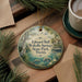 A round ornament with a scenic image of Edward Ball Wakulla Springs, Florida, hanging on a wooden surface.