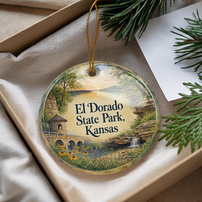 A decorative ornament with a scenic landscape of El Dorado State Park, Kansas, featuring a bridge, waterfall, and trees.