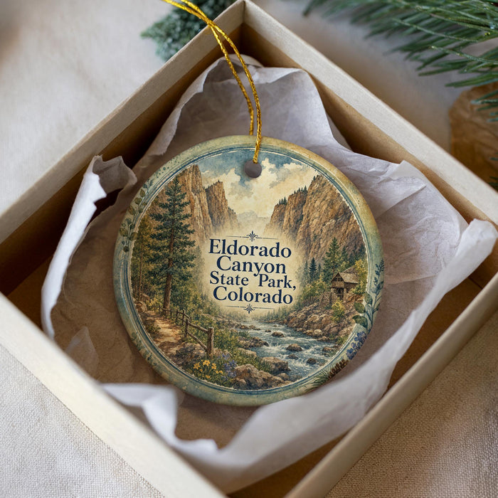 A decorative ornament in a box, featuring a scenic image of Eldorado Canyon State Park, Colorado.