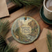 A decorative ornament featuring a scenic landscape of Eldorado Canyon State Park, Colorado, with a winding path and a river flowing through the mountains.
