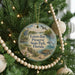 A round ornament hanging on a Christmas tree, featuring a bird, a dolphin, and a beach scene, with the text "Estero Bay Preserve State Park, Florida" displayed on it.