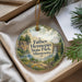A round ornament with a scenic landscape of Father Henepin State Park, Minnesota, hanging from a string.