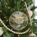 A round ornament on a Christmas tree, featuring a scenic landscape with a river and mountains, with the text "Ferne Clyffe State Park, Illinois" displayed on it.