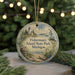 A round ornament with a lighthouse and a boat, hanging on a string, with the text "Fisherman's Island State Park, Michigan" displayed on it.