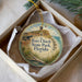 A decorative ornament in a box, featuring a painting of Fort Clinch State Park in Florida.