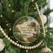 A round ornament hanging on a Christmas tree, featuring a scenic image of Fort Cooper State Park in Florida.